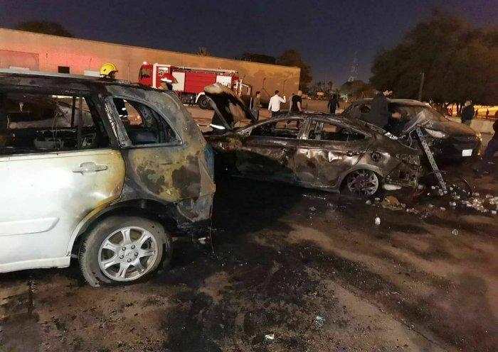 ifmat - Charred cars are seen after a rocket strike on the Green Zone in central Baghdad